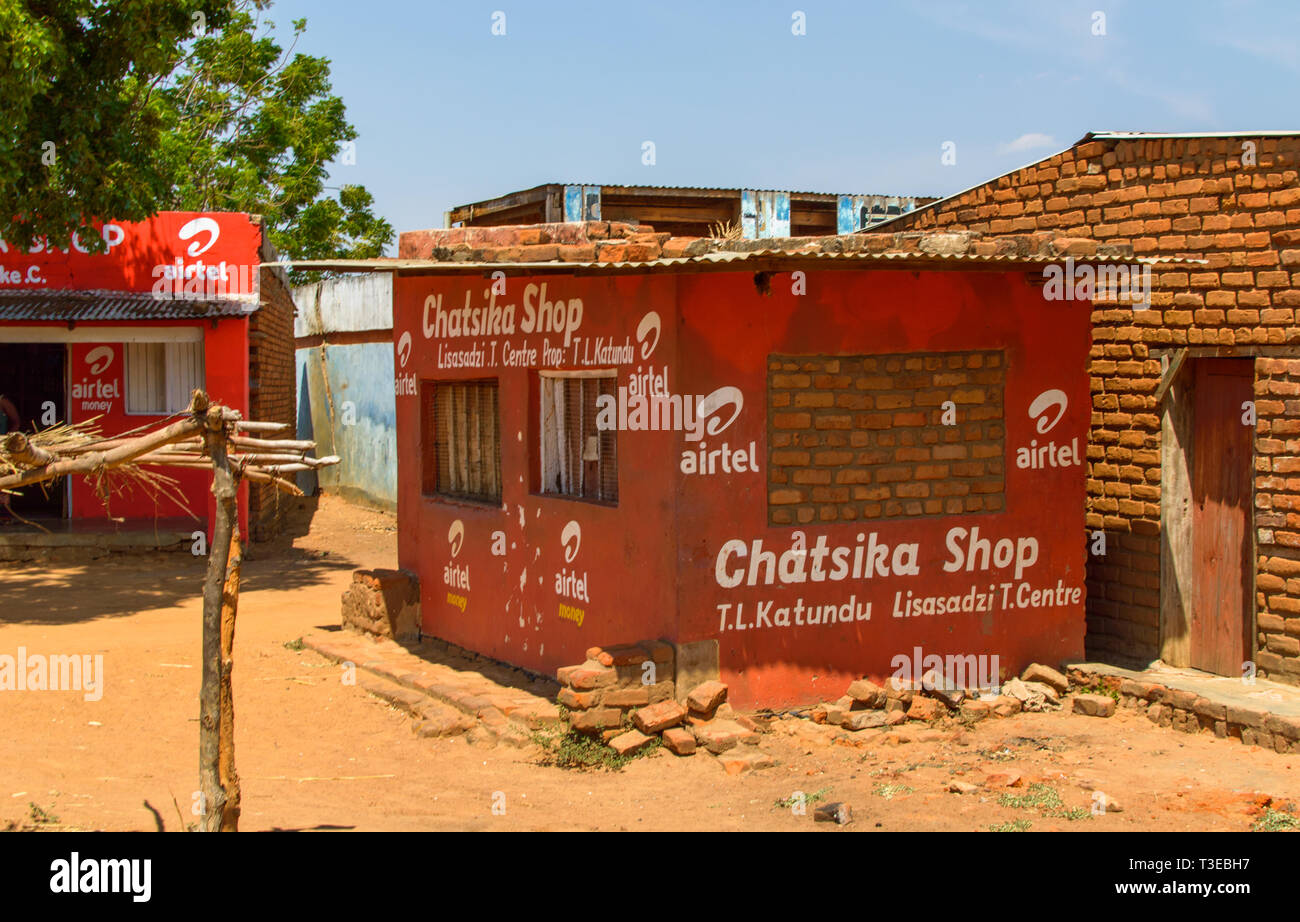 small shop or kiosk selling mobile phone data painted in colours and with name of network Malawi Stock Photo