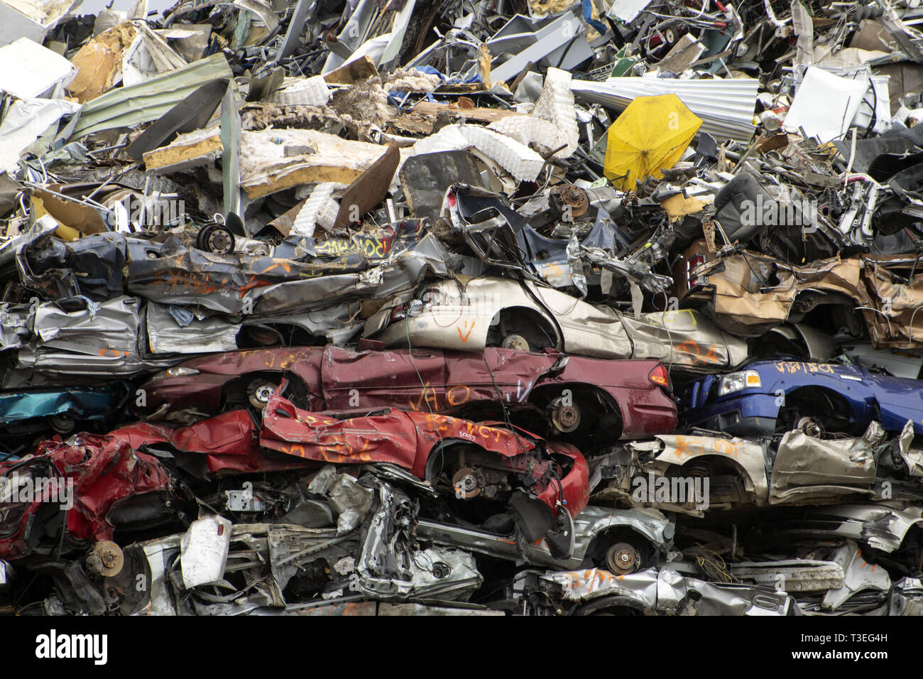 piles of wrecked cars in a junk yard Stock Photo