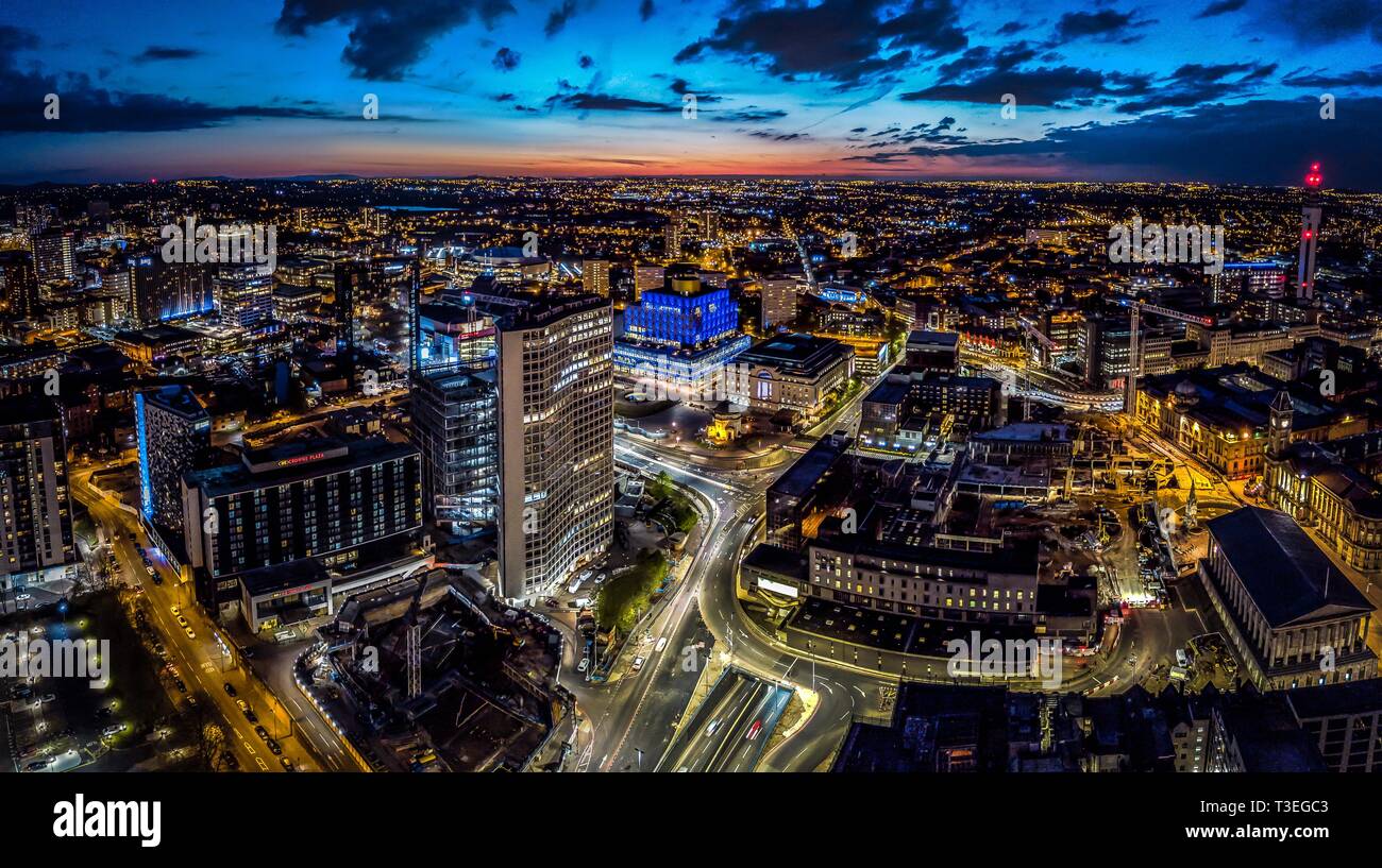 Birmingham, UK aerial from drone at sunset - night. Includes library, Town Hall, BT Tower and skyline. Stock Photo