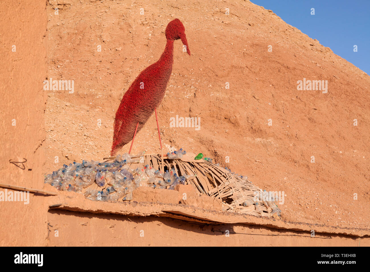 A red statue of a bird at the Ksar Aït-Ben-Haddou, Aït Benhaddou‌, Ouarzazate Province, Drâa-Tafilalet, Morocco, Africa. Stock Photo