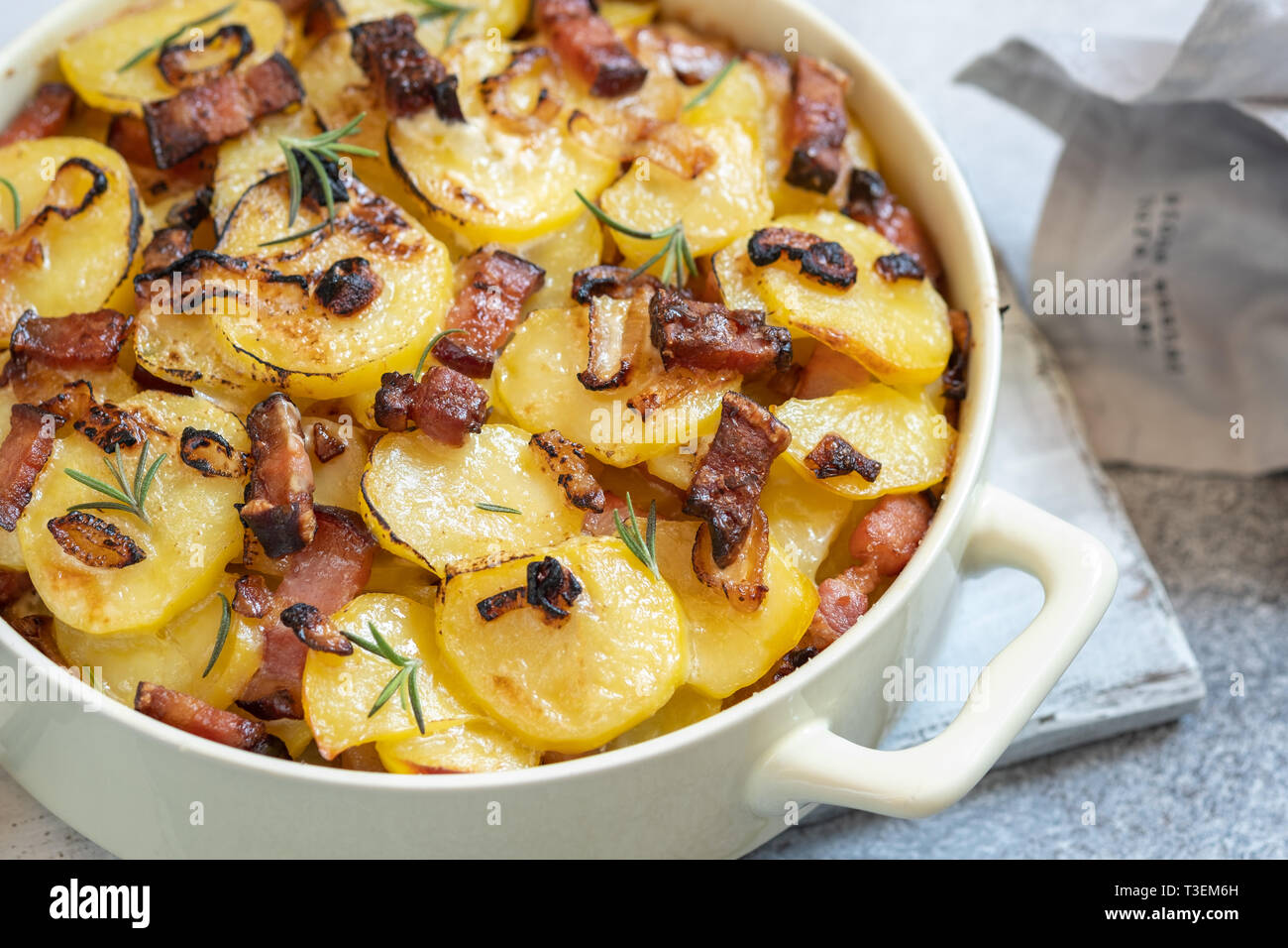 scalloped potatoes roasted with bacon and onion Stock Photo Alamy