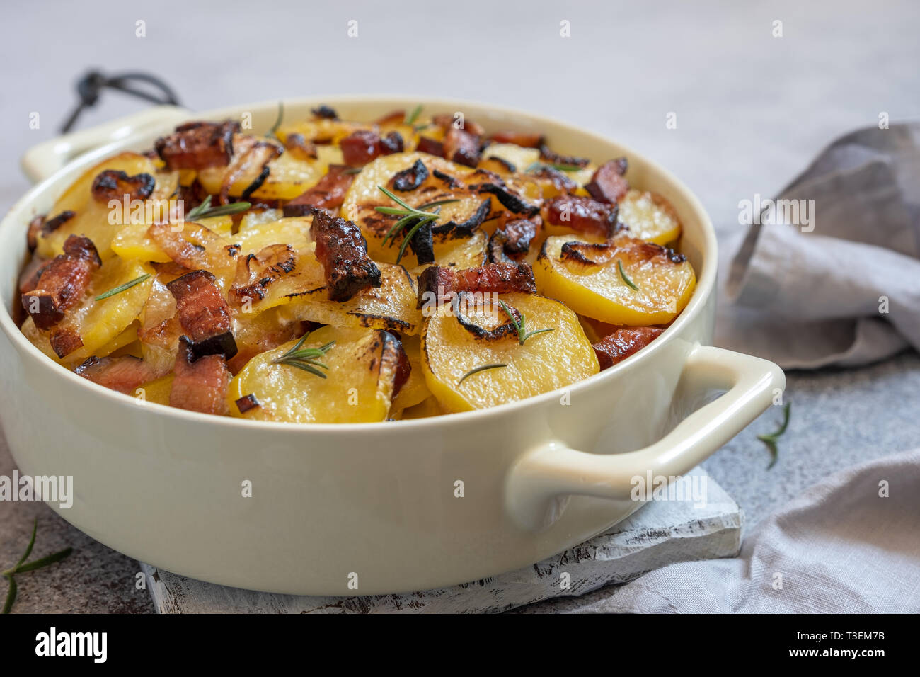 scalloped potatoes roasted with bacon and onion Stock Photo Alamy