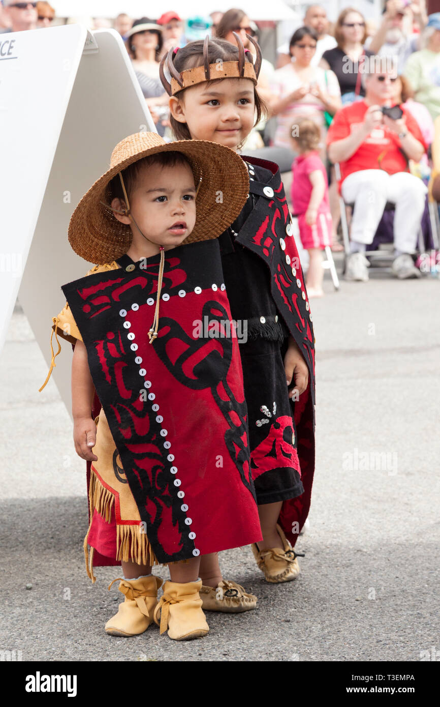 Native American children wearing traditional clothing at the Penn Cove Water Festival. Pacific Northwest Haida Tlingit Indian tribes. Stock Photo