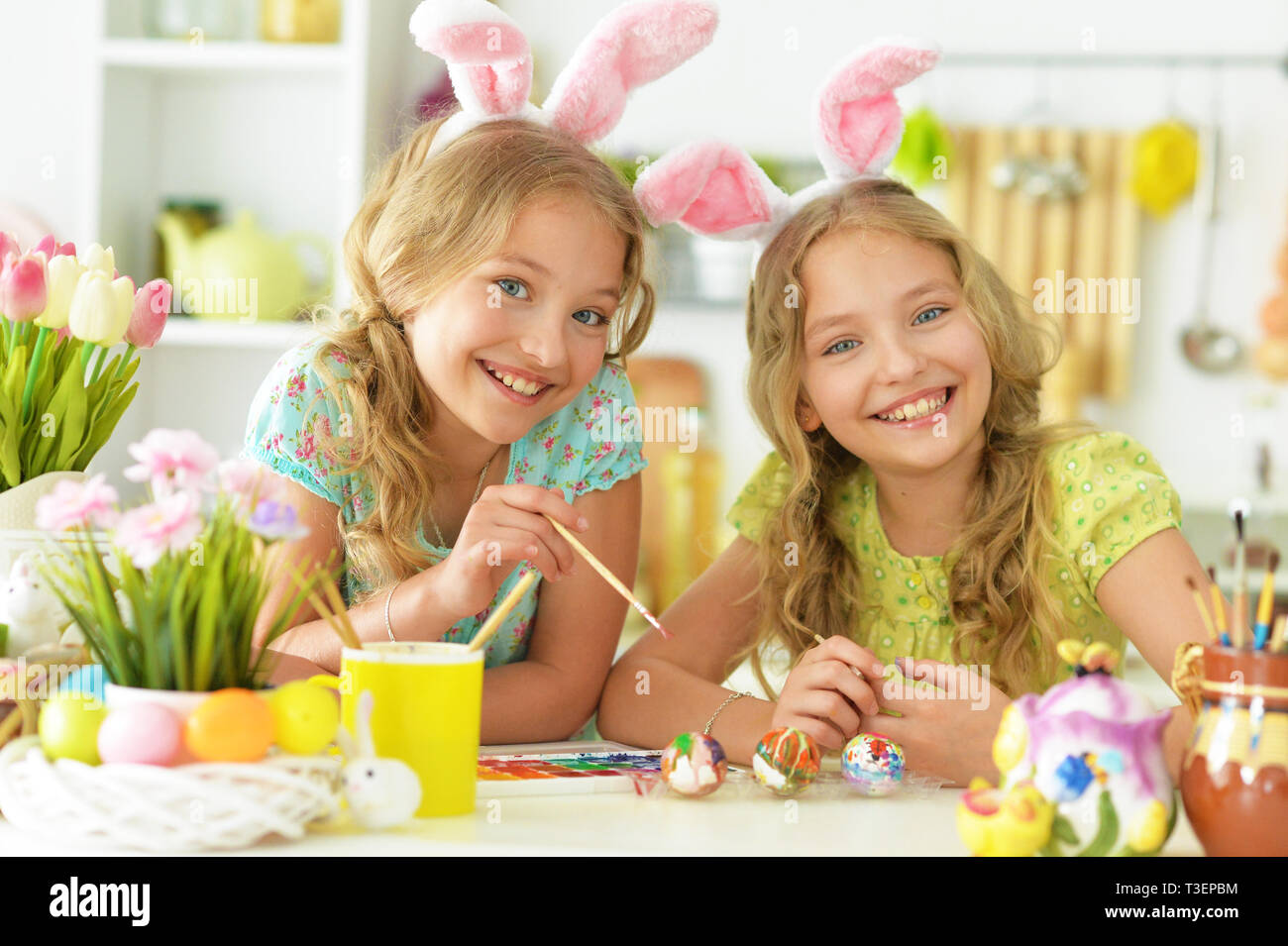 Portrait of sisters preparing for Easter in the kitchen Stock Photo