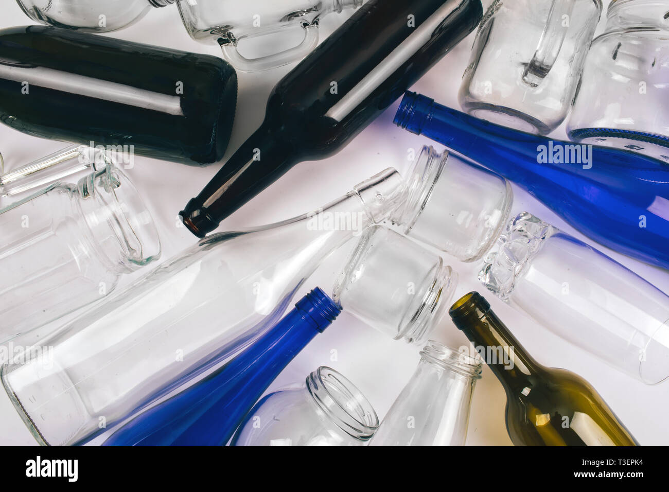 Reduce reuse recycle. Sorting waste. Empty blue, green glass bottles