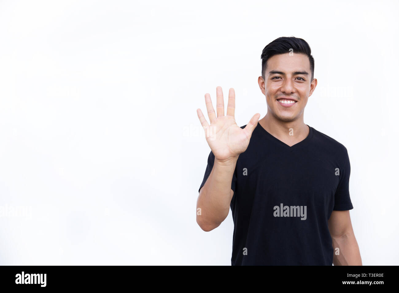 Handsome latin hispanic man is showing five fingers isolated on white background. Place for text and design. Stock Photo