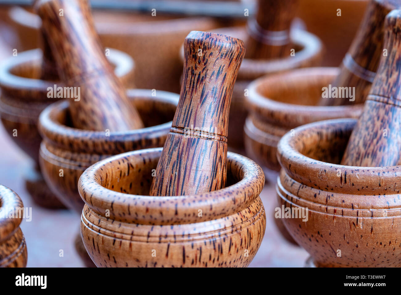 Wooden mortar and pestle for sell in local street market in Thailand, close  up. Thai souvenir for tourist Stock Photo - Alamy