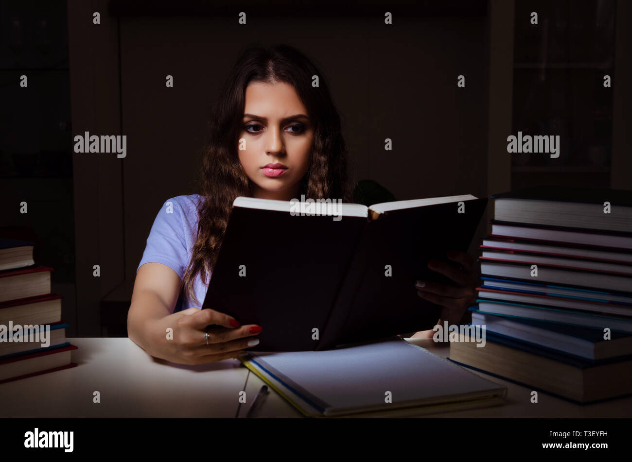 Young female student preparing for exams late at home Stock Photo - Alamy