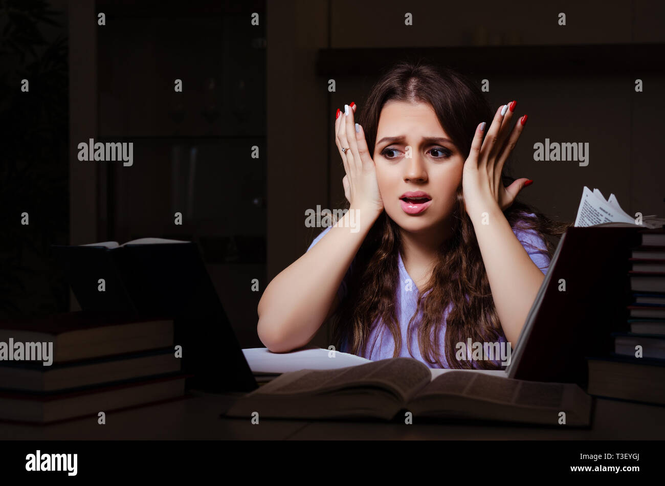 Young female student preparing for exams late at home Stock Photo - Alamy