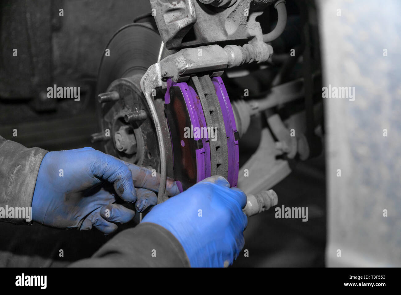 Close Up Professional Car Mechanic Changing Front Brake Pads In