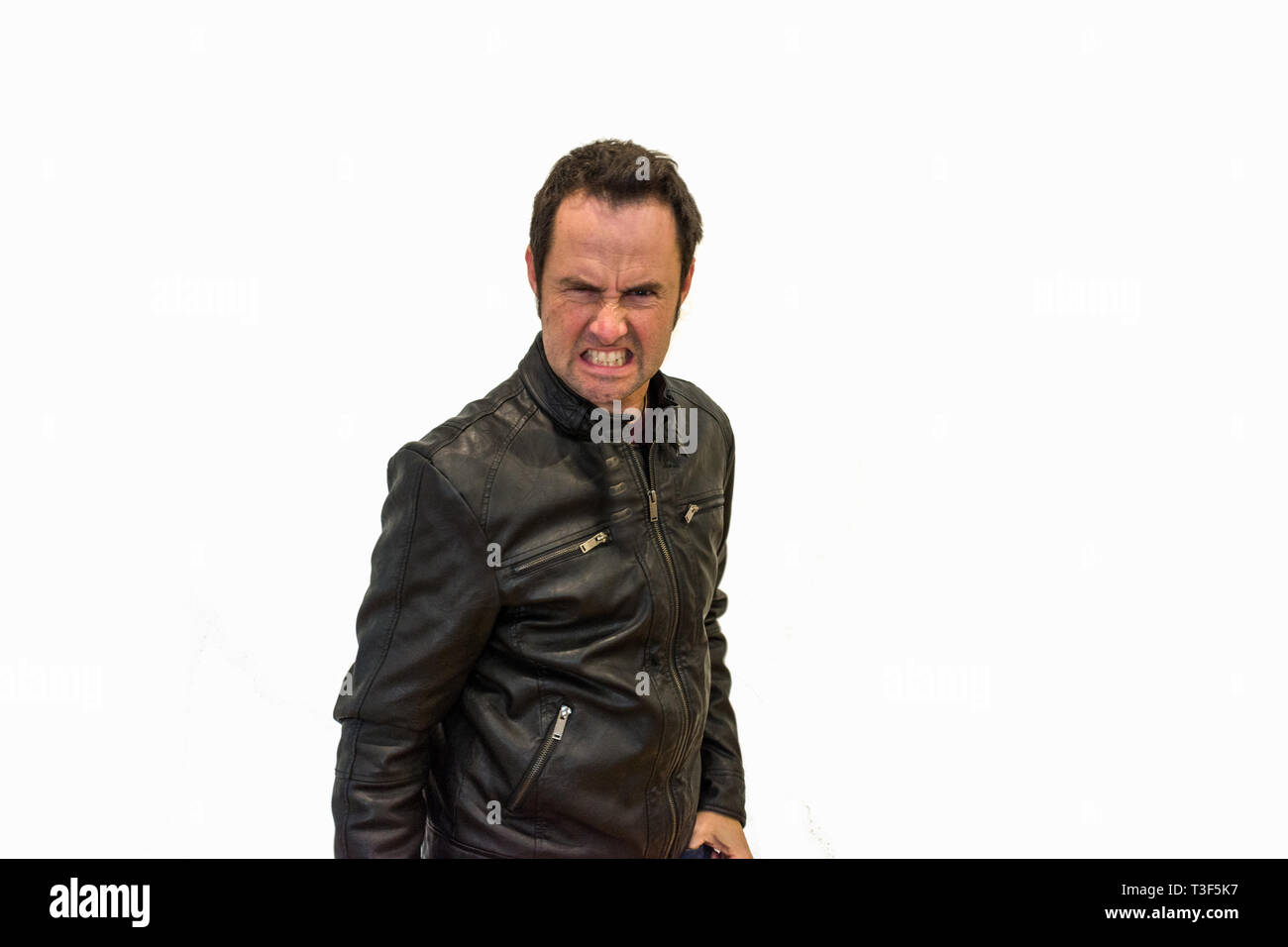 Angry man with black jacket on white background Stock Photo