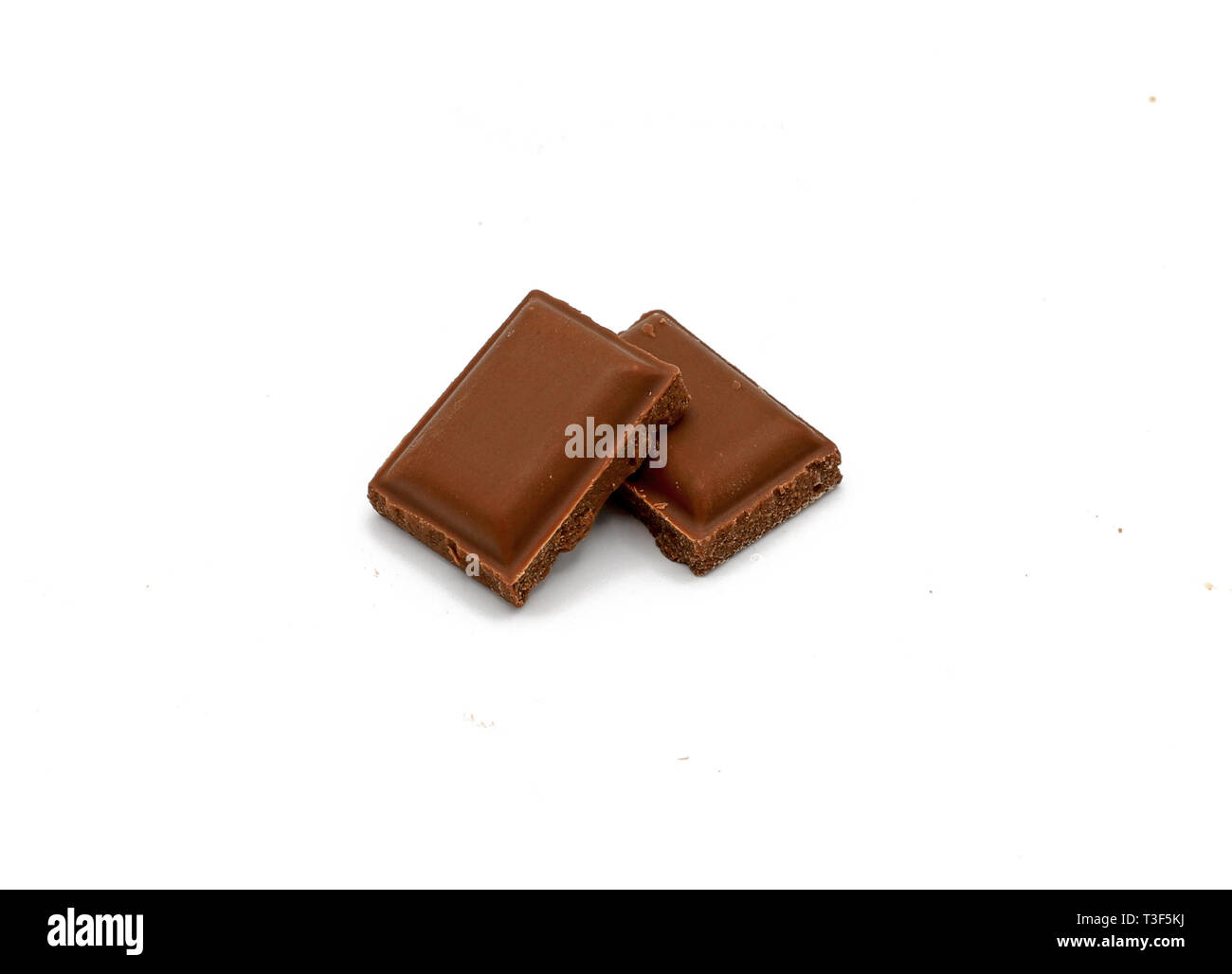 Milk chocolate pieces - isolated on white Stock Photo