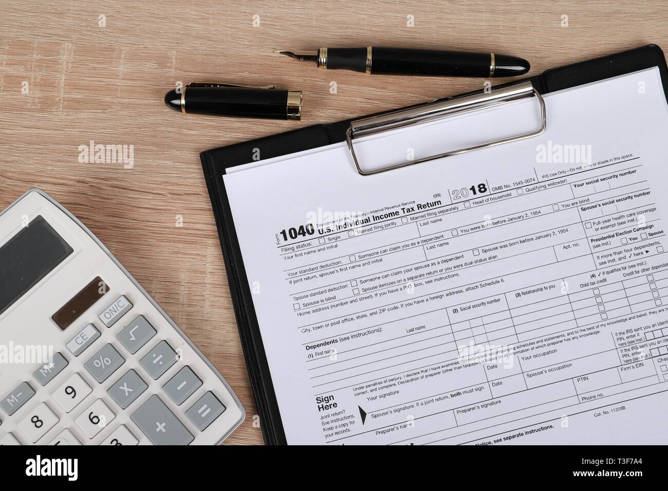 1065 tax form lies near hundred dollar bil and calculator  on a Table. US Return for parentship income Stock Photo