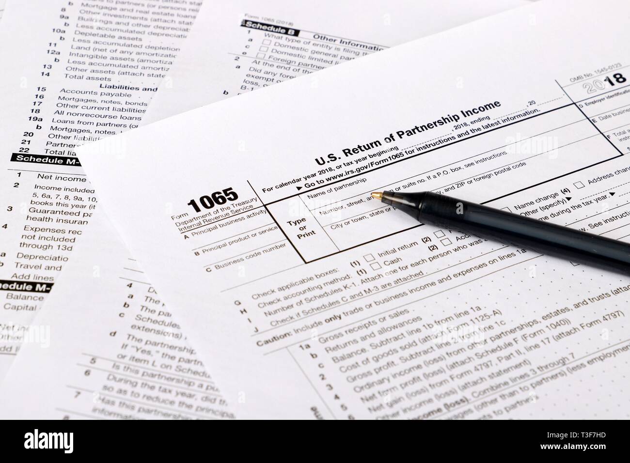 1065 tax form and pen on a Table - US Return for parentship income Stock Photo