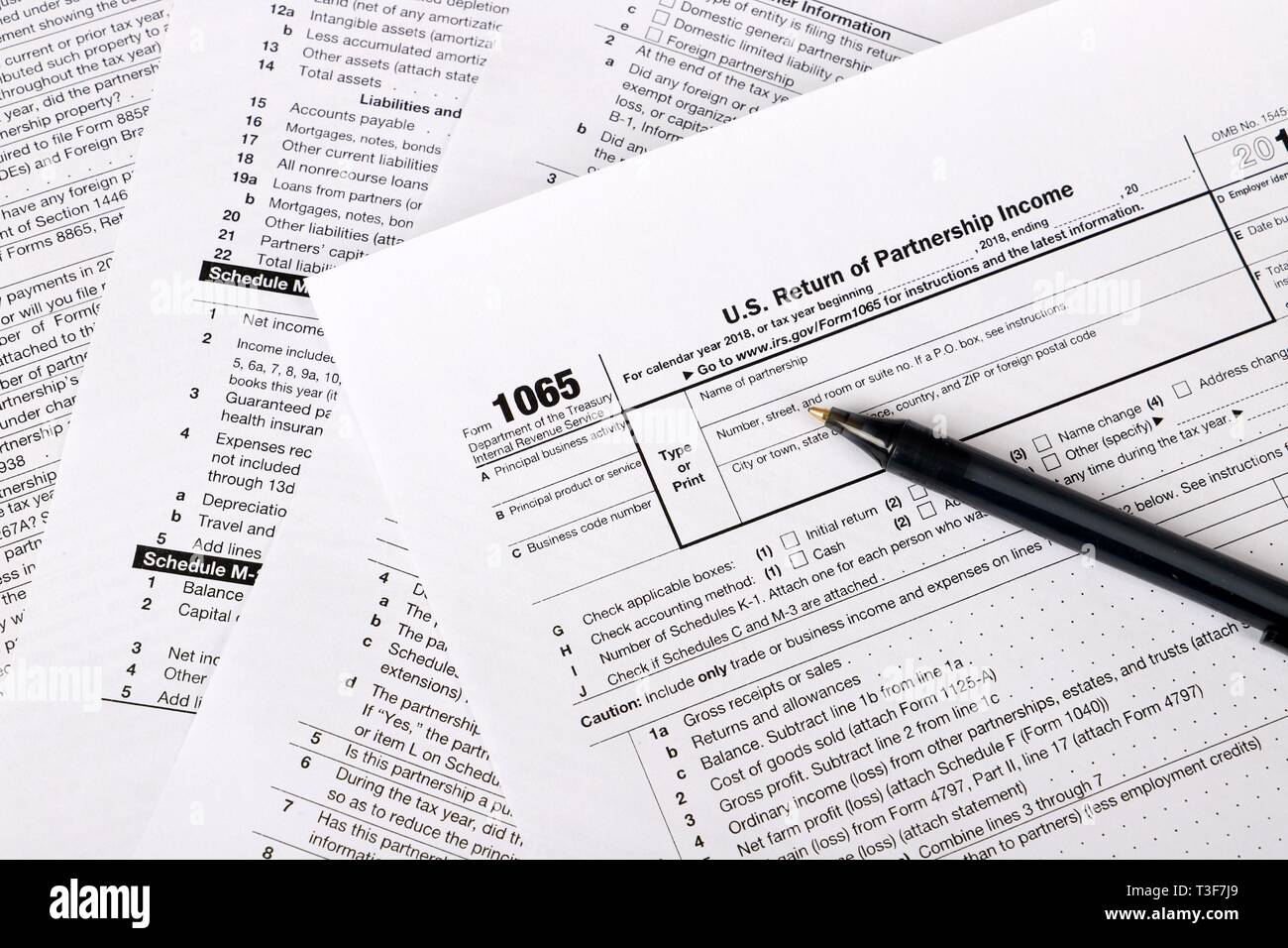 1065 tax form and pen on a Table - US Return for parentship income Stock Photo