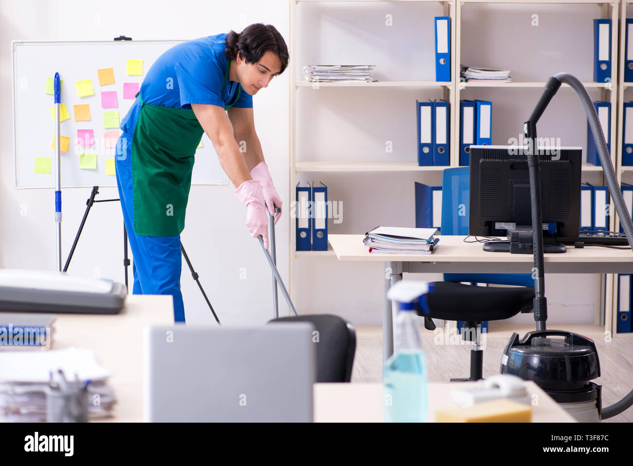 Male handsome professional cleaner working in the office Stock Photo