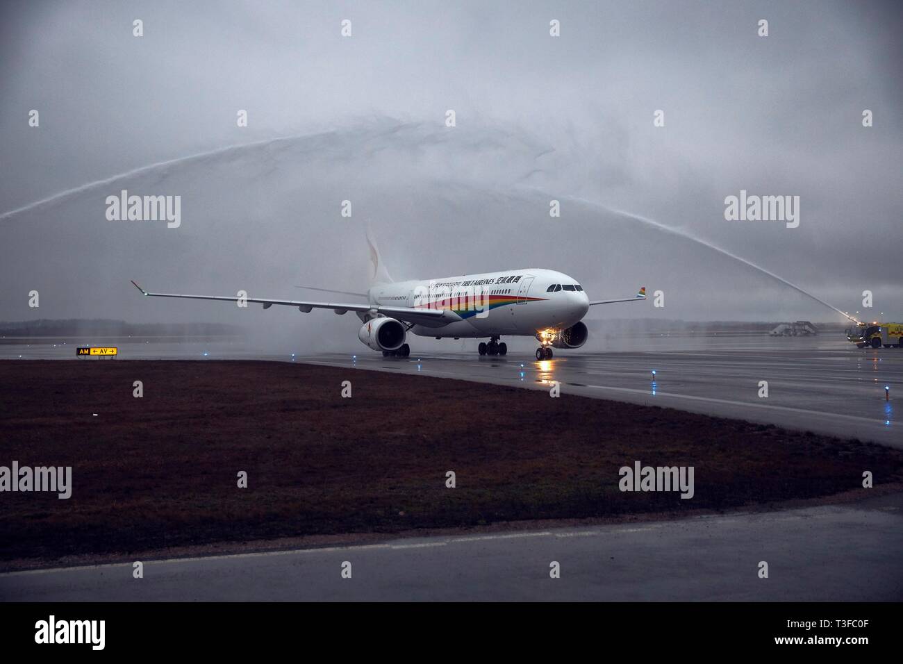 (190409) -- VANTAA, April 9, 2019 (Xinhua) -- Tibet Airlines' inaugural flight from Jinan, the capital city of eastern China's Shandong Province, lands at the Helsinki-Vantaa International Airport in Finland, April 8, 2019. An Airbus 330 operated by China Tibet Airlines landed at the Helsinki-Vantaa International Airport late on Monday, opening the weekly direct flights between Jinan, Shandong Province of China and Helsinki, capital of Finland. Tibet Airlines has one flight to Finland every week in April and will possibly run two weekly flights in June. (Xinhua/Finavia) Stock Photo