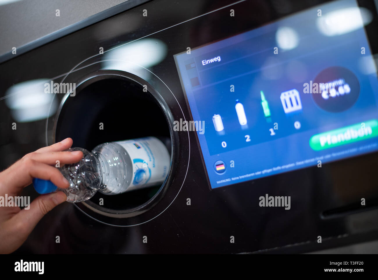 Berlin, Germany. 08th Apr, 2019. A man puts a deposit bottle into a