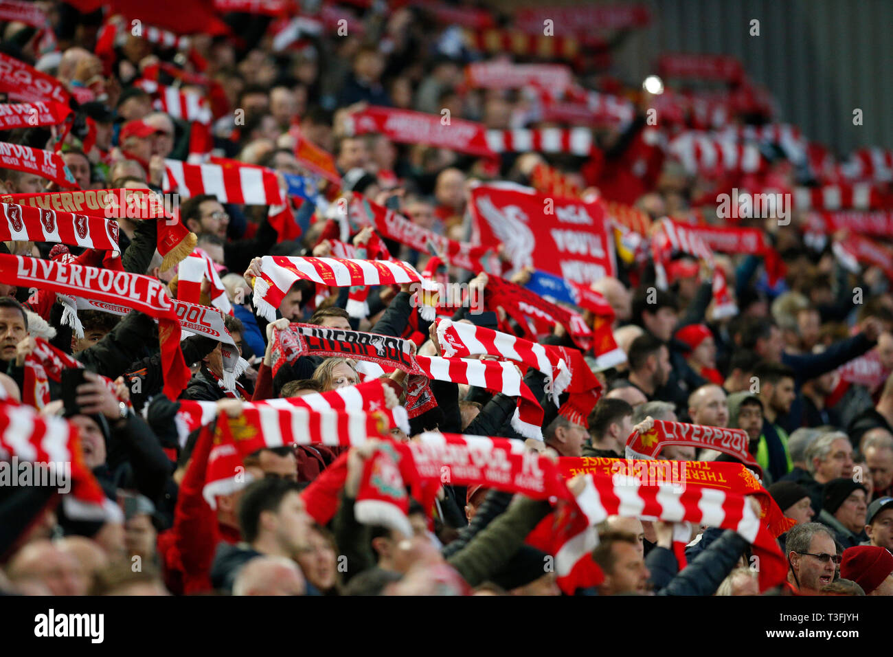 Liverpool, UK. 09th Apr, 2019. Liverpool fans hold their scarves aloft during the singing of 'You'll Never Walk Alone' before the UEFA Champions League Quarter Final first leg match between Liverpool and Porto at Anfield on April 9th 2019 in Liverpool Credit: PHC Images/Alamy Live News Stock Photo