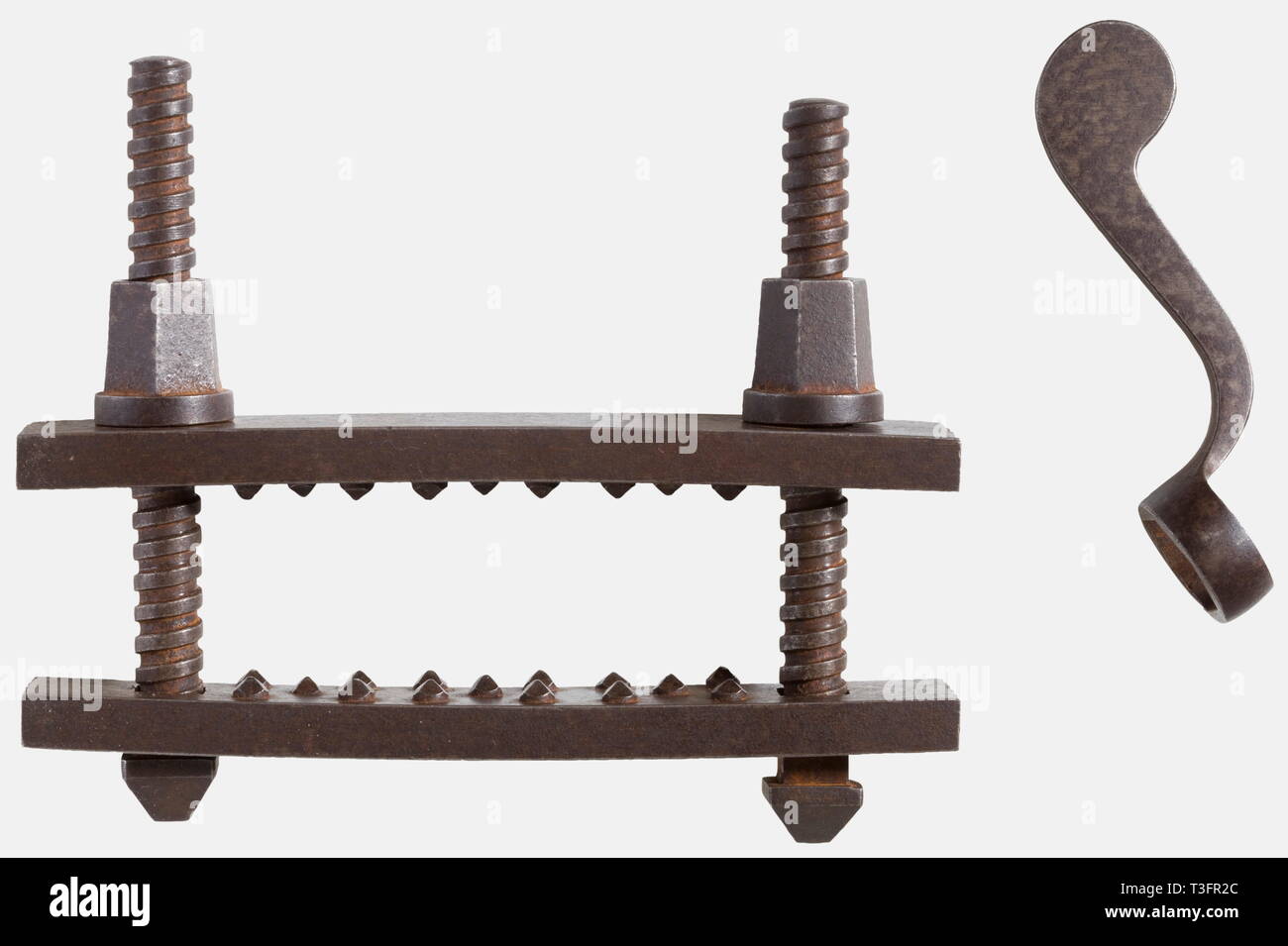 An Austrian thumbscrew, 2nd half of the 18th century Forged iron. Heavy, slightly curved vice jaws, each fitted with three rows of inset quadrangular studs. Decorative cutting on the sides. The threaded bars have slightly tapered nuts. It comes with the original adjustment key. Width 12.6 cm. Carefully crafted thumbscrew. It corresponds exactly in every detail, to the pattern from the Constitutio Criminalis Theresiana of 1768. historic, historical, 18th century, instrument of torture, torture device, instruments of torture, torture devices, objec, Additional-Rights-Clearance-Info-Not-Available Stock Photo