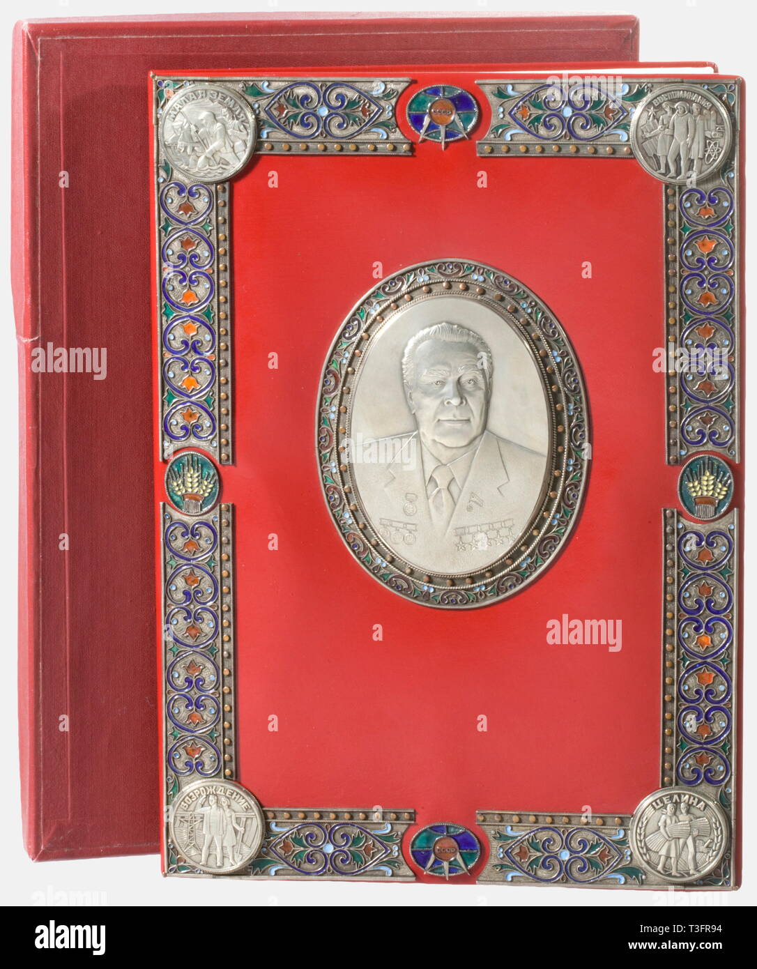 Leonid Ilyich Breshnev (1906 - 1982), a presentation folder for his literary trilogy Red artificial leather folder with nickel-silver mountings, partially engraved and enamelled with floral designs, and with his nickel-silver portrait in the centre. Four agates in settings on the back. Dimensions 35 x 25.5 cm. In the original red box. The Breshnev trilogy (1978 - 79), which was published under Breshnev's name to improve his public image, consists of three autobiographical novels ('Malaya Zemlia', 'Vzroshdenie', 'Zelina'). Although not the author , Additional-Rights-Clearance-Info-Not-Available Stock Photo