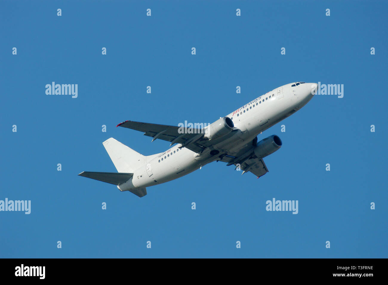 JAT Airways Boeing 737 jet airliner plane YU-ANI taking off from London Heathrow Airport, London, UK in blue sky. Plain white scheme Stock Photo
