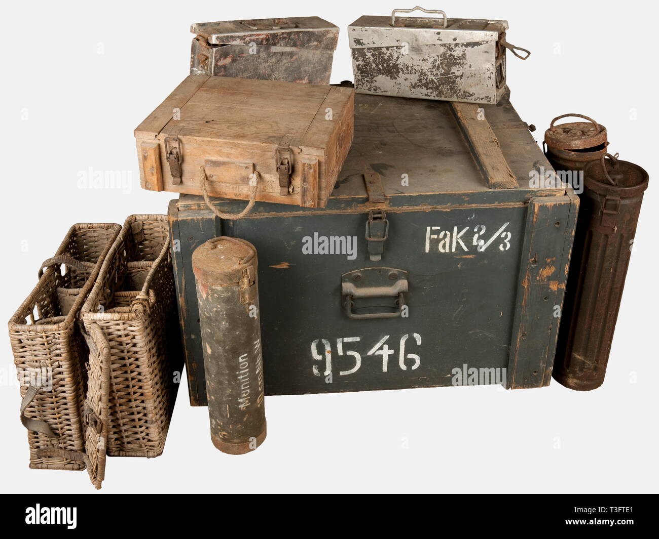 A group of German transport containers, including two rectangular baskets for three 7,7 cm shells (one without its cover, one with a broken strap), a very rare wooden case for two Luftwaffe parachutes painted grey-blue and marked 'Fak 2/3' and '9546', a cylindrical feldgrau painted cardboard canister for 10 cm Nebelwerfer rockets with rusted green painted metallic cover with handle and white marking on the side 'Munition 10cm NBW', a rectangular wood case for ammunitions with cord handle and remains of a beige tab, and two aluminium MG 34/42 belt canisters with remains of t, Editorial-Use-Only Stock Photo