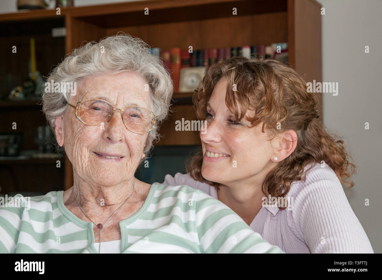 Portrait of smiling senior lady and young granddaughter Stock Photo