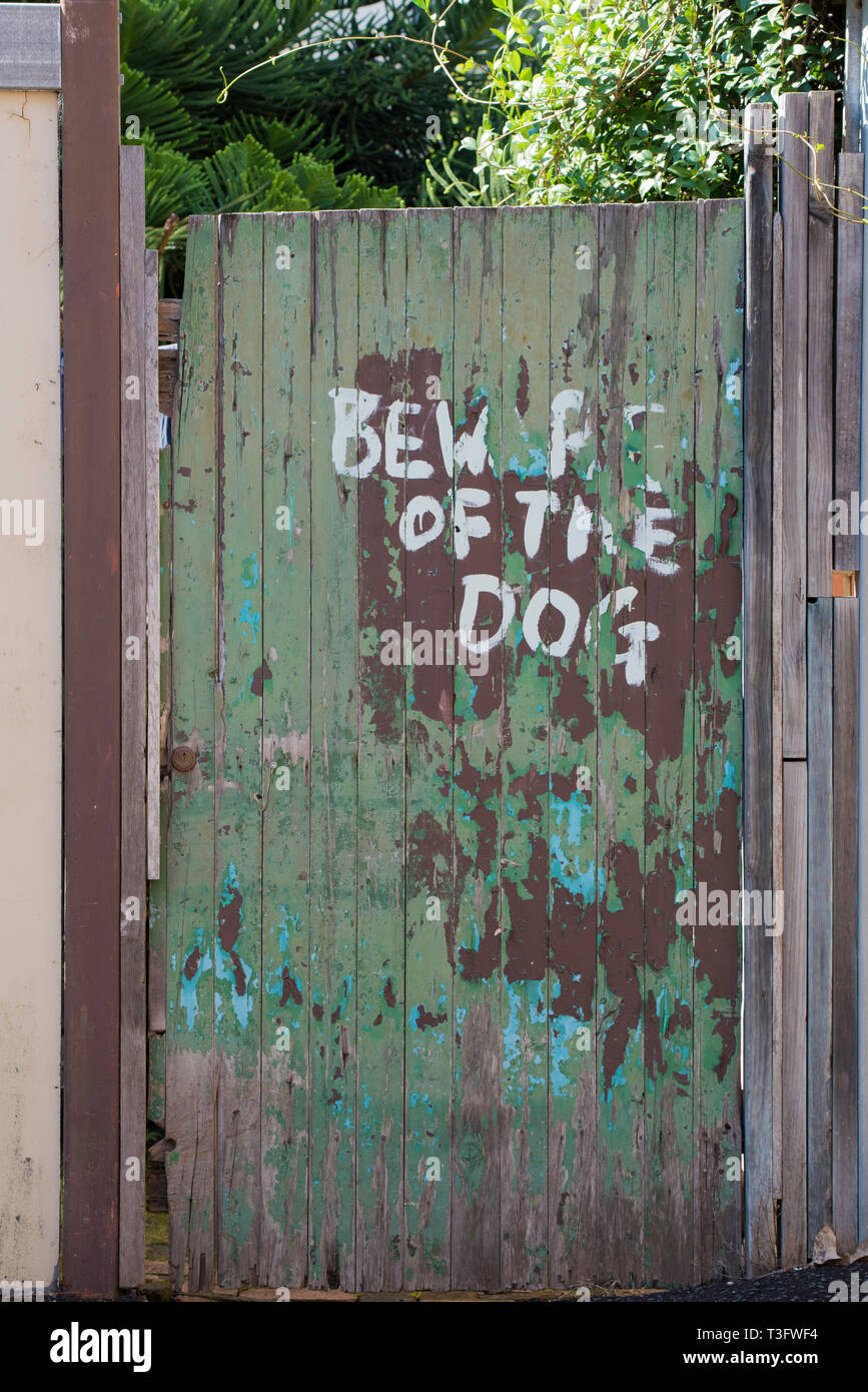 A hand painted Beware of the dog sign on a timber gate in a back street of  the Sydney suburb of Surry Hills, NSW Australia Stock Photo