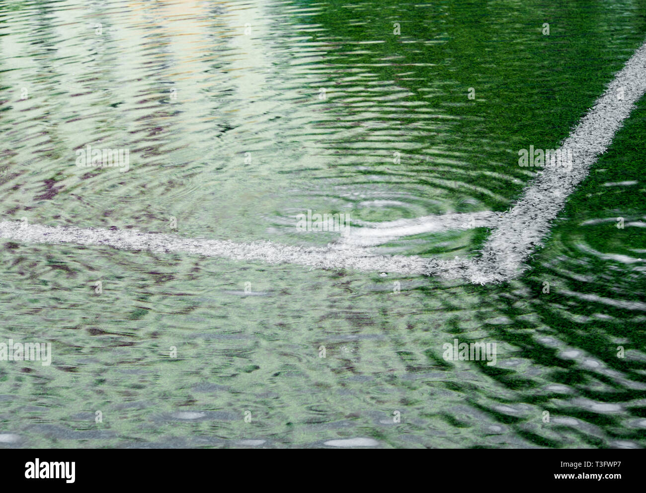 Flooding in artificial grass football field. After heavy rain Stock ...