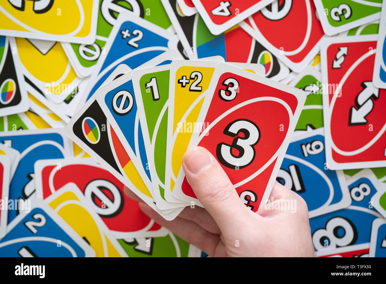 Deck of Uno Game Cards Scattered All Over on a Table. American