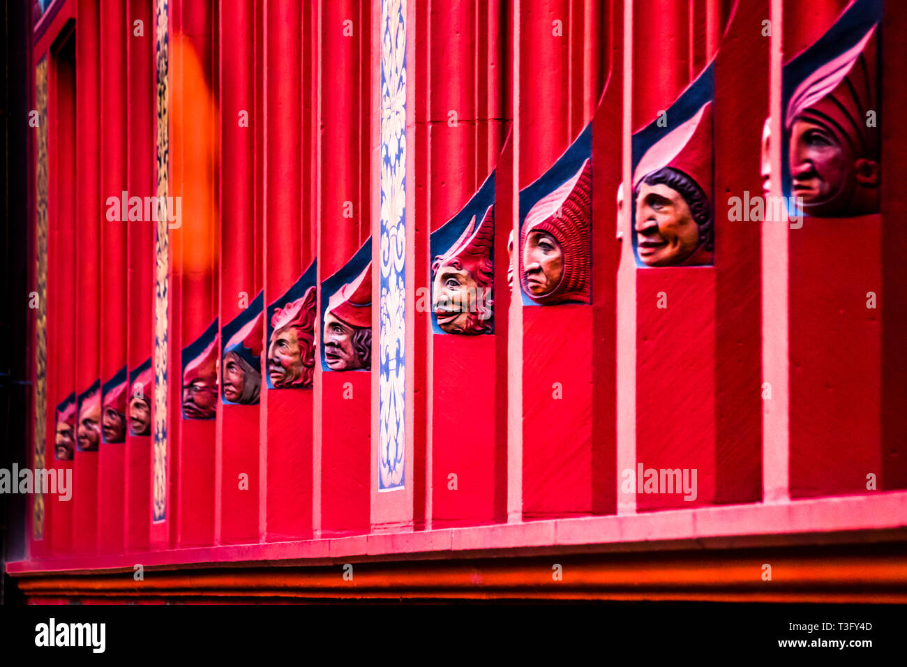 Detail of the Red Town Hall of Basel. It is located directly on the market square and the forecourt is freely accessible. Faces on the facade of Basel townhall, Switzerland Stock Photo