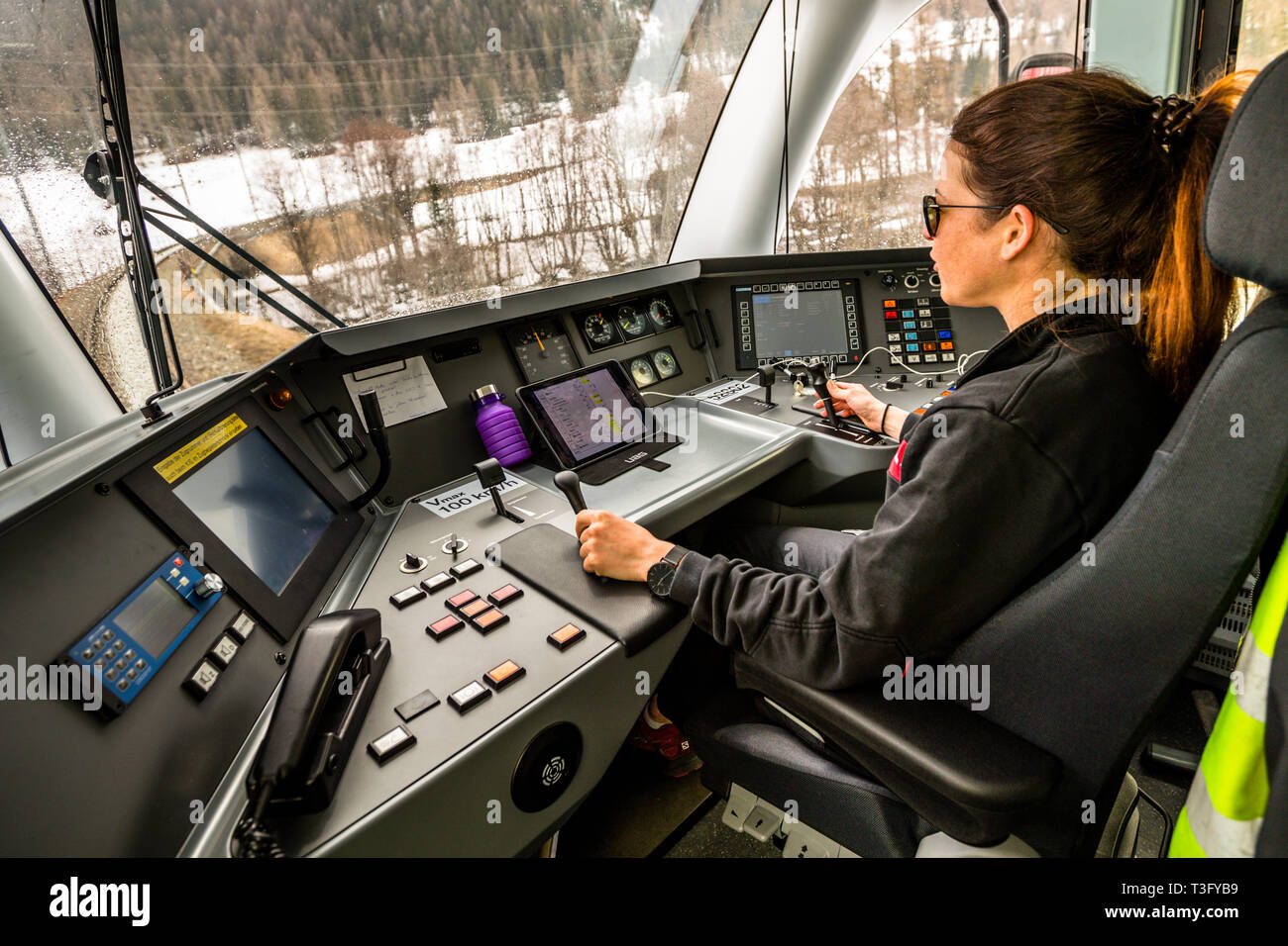 Female train driver in Switzerland. The train ride in a driver's cab of the Rhaetian Railway is a very special experience and can be booked in advance Stock Photo