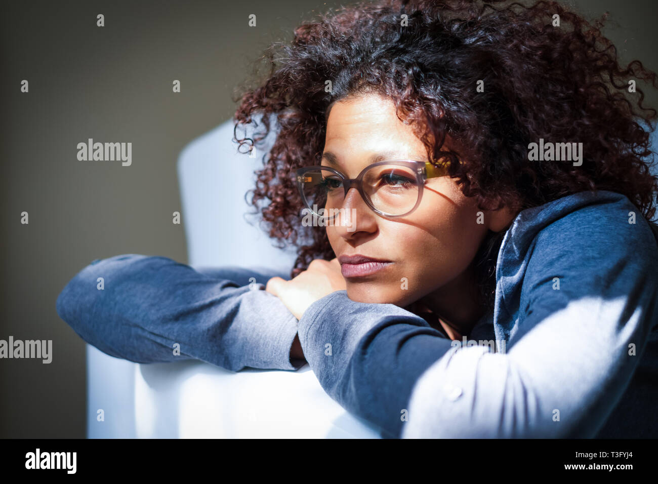 Woman feeling negative emotions lying on the sofa Stock Photo
