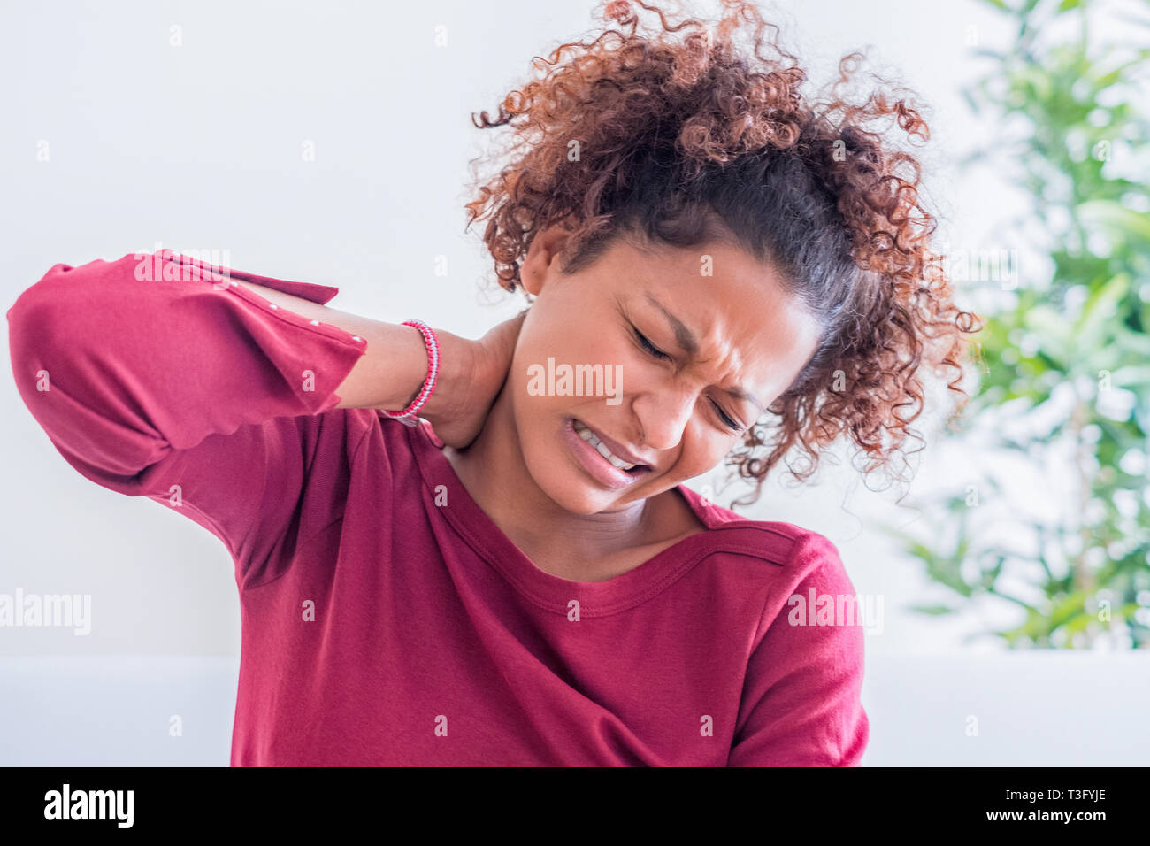 Young black woman suffer shoulder and neck pain Stock Photo