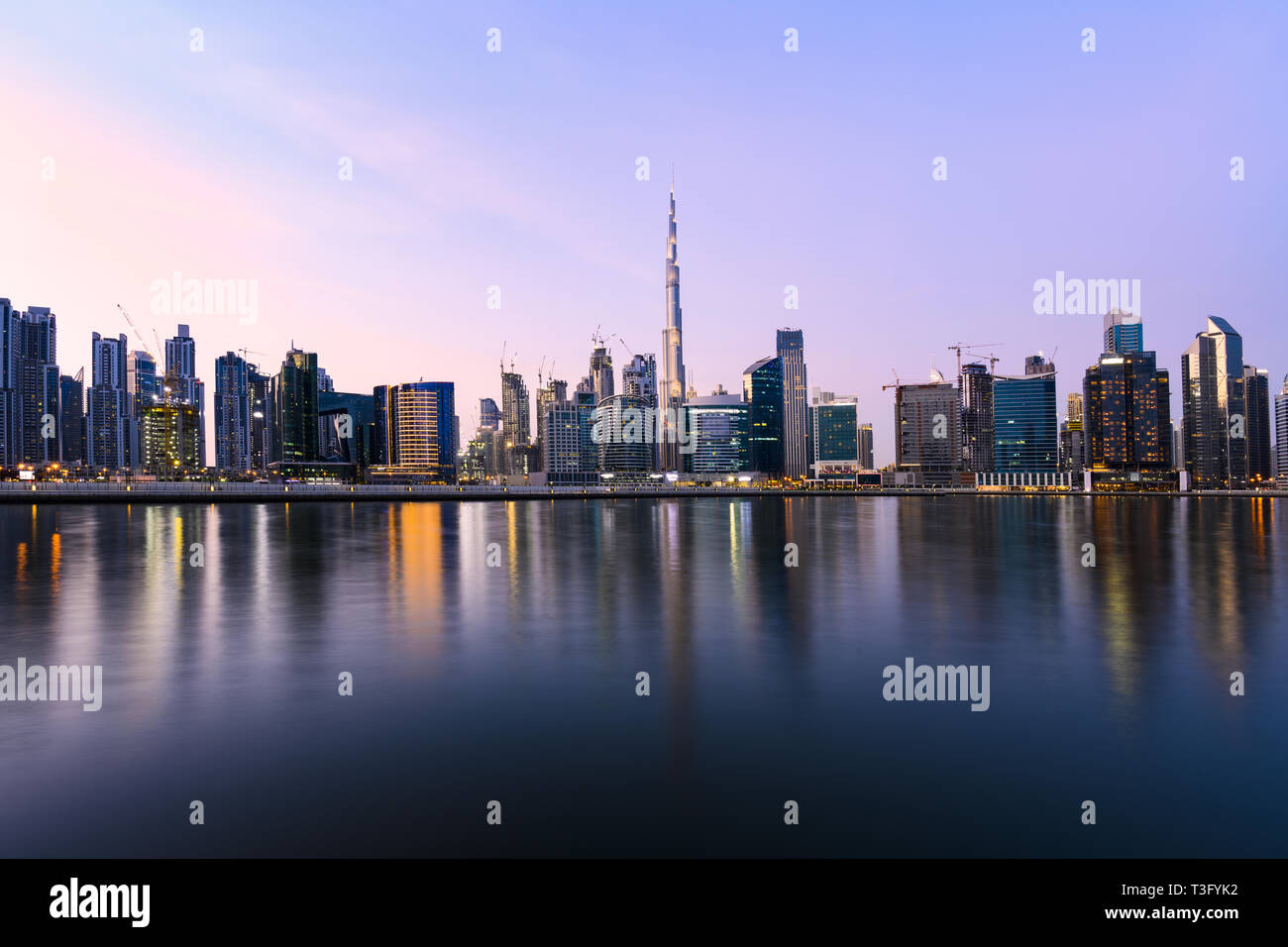 Stunning panoramic view of the Dubai skyline during sunset with the magnificent Burj Khalifa and many other buildings and skyscrapers. Dubai, UEA. Stock Photo