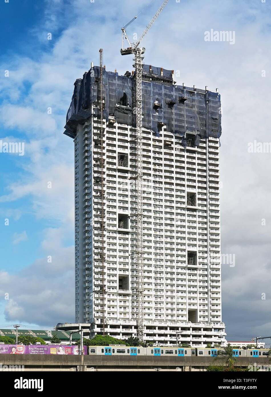 Manila, Philippines - January 17, 2017: Torre de Manila building while under construction, controversial due to its proximity to the Rizal Monument Stock Photo