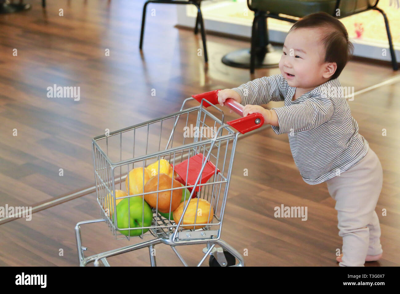 baby pushing shopping cart