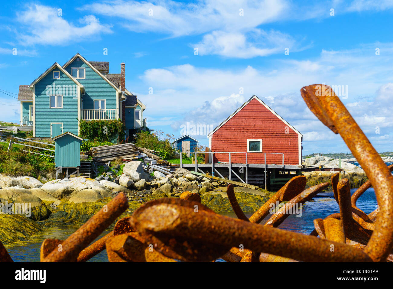 View of rusty anchors, and colorful houses, in the fishing village