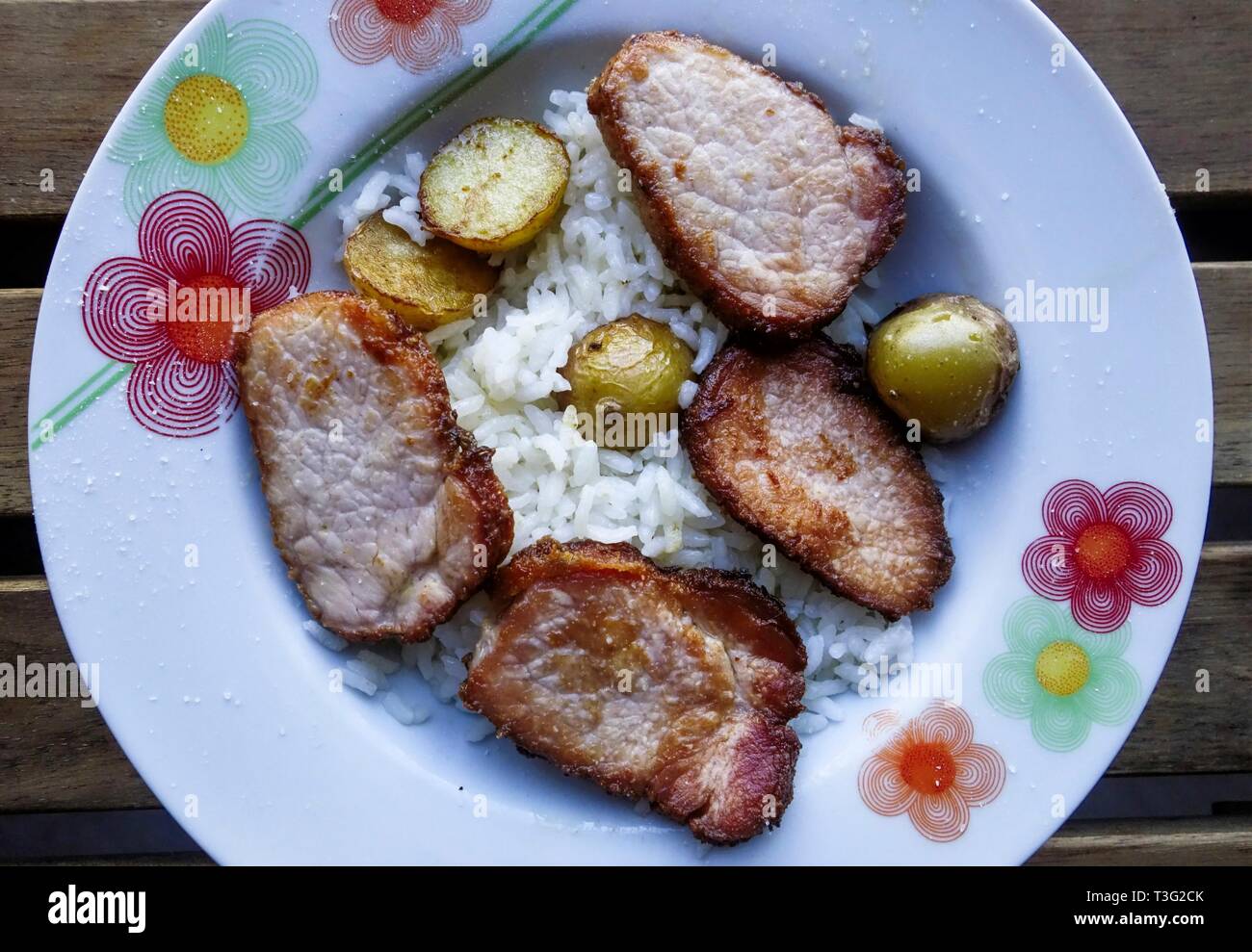 Greek Cuisine. Smoked Pork Fillet Apaki with Rice, Roast Potatoes and