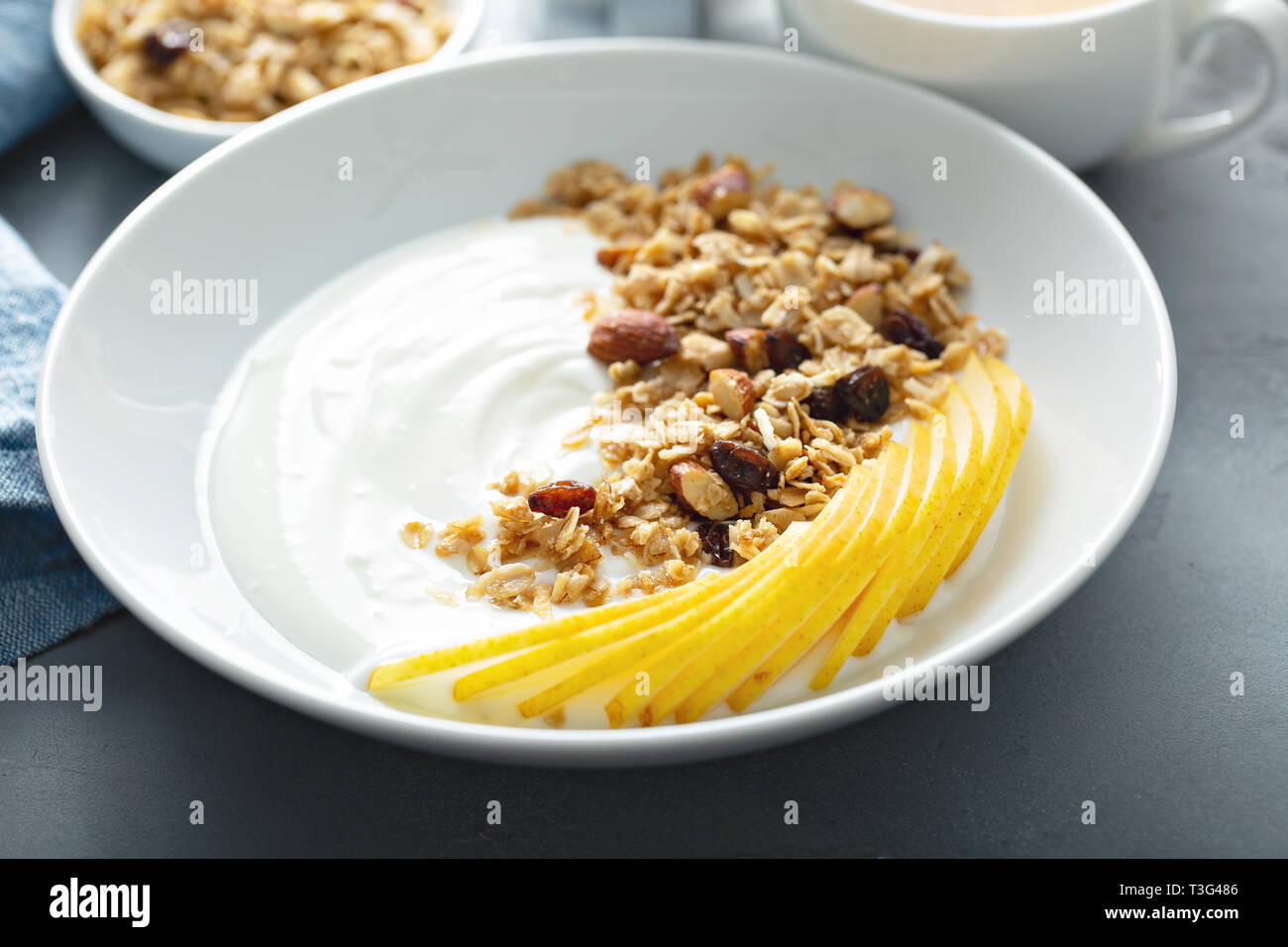 Plain yogurt with granola and pear Stock Photo