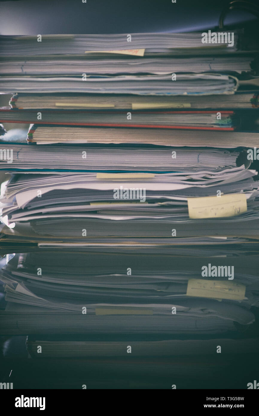 Pile of paperwork on a table with a gritty look Stock Photo