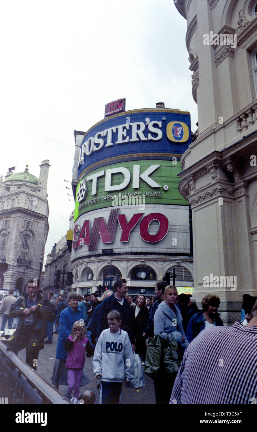 TDK and Sanyo adverts seen behind congested sidewalk in Piccadilly Circus in London England ca. 1998 Stock Photo