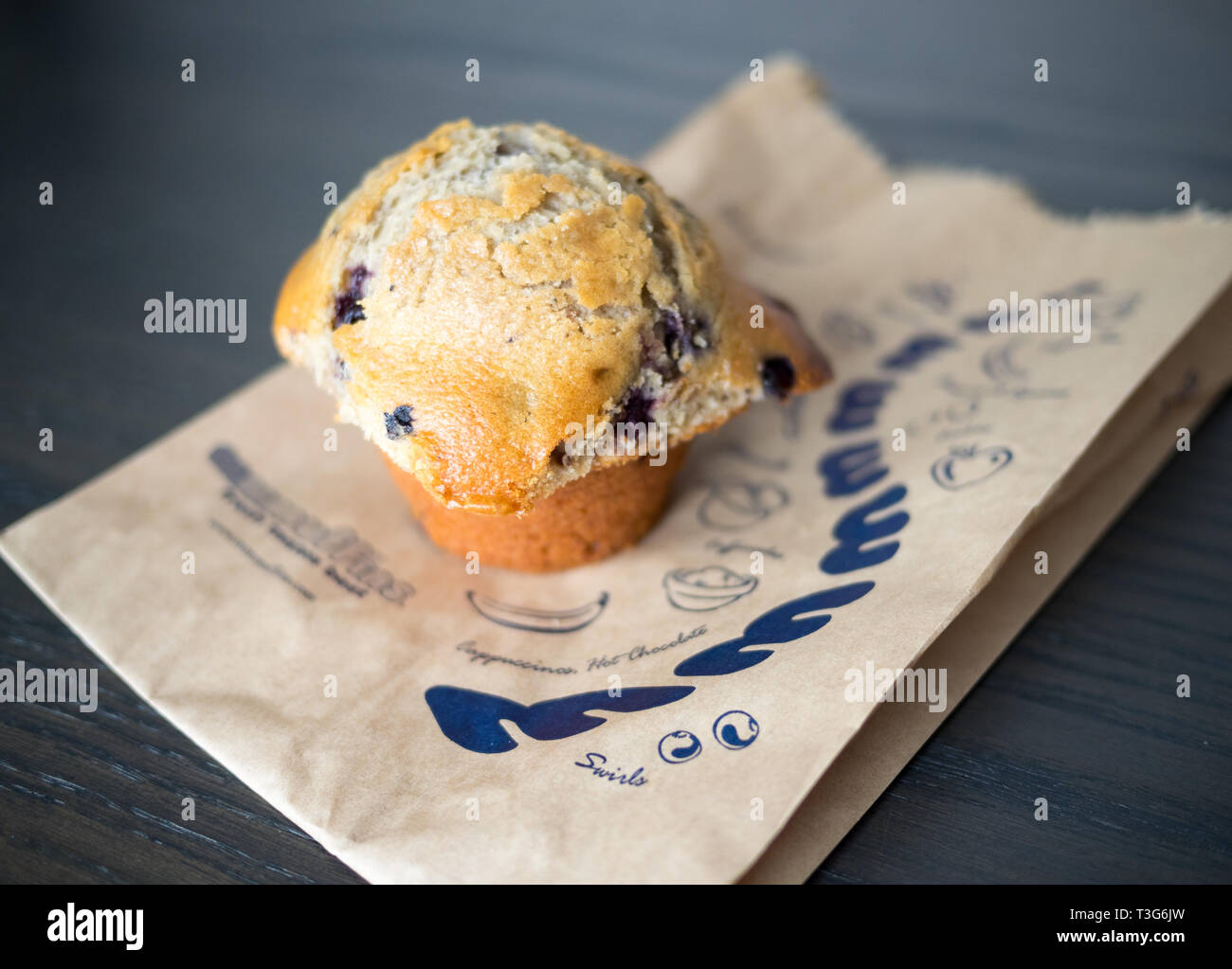 A blueberry muffin from Mmmuffins (also known as Marvellous Mmmuffins), a once popular Canadian restaurant chain specializing in muffins and coffee. Stock Photo