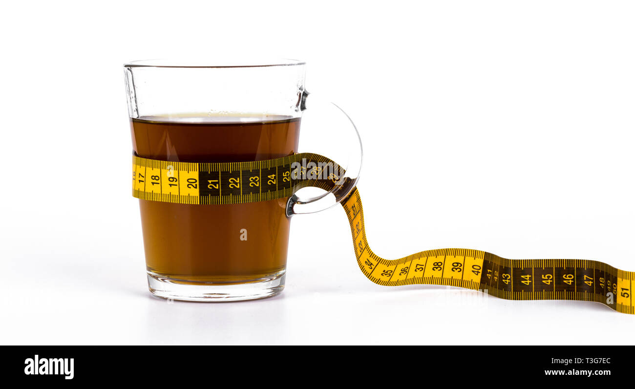 Slimming tea, cup with tea with lemon and measuring tape isolated on white background Stock Photo