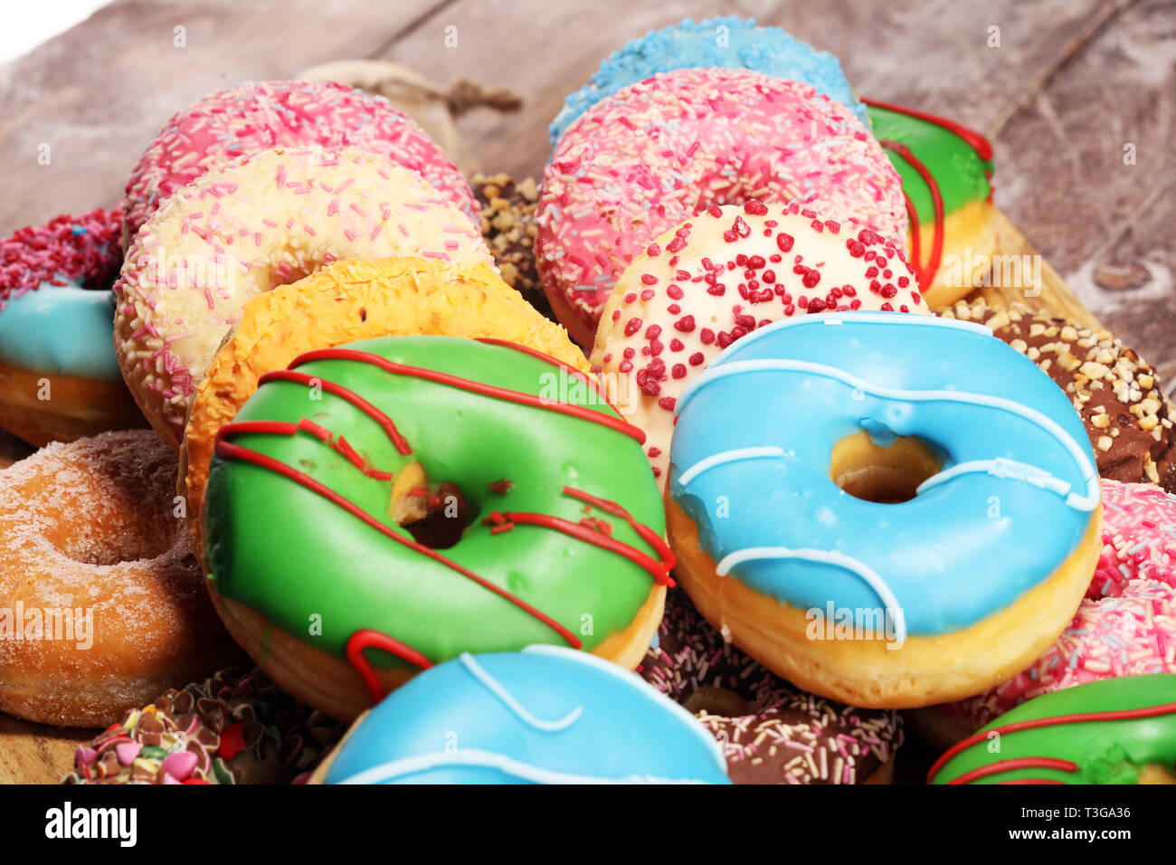 assorted donuts with chocolate frosted, pink glazed and sprinkles