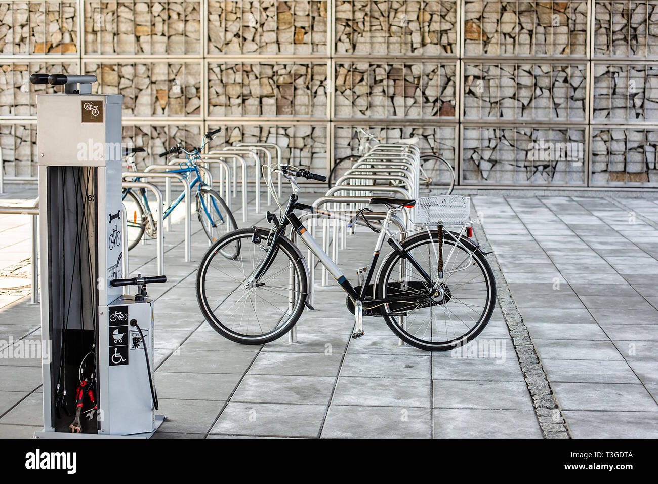 Parking space for bicycles. Bicycle in the parking lot, a lot of empty  seats. The bike is chained to the bike rack in the city Stock Photo - Alamy