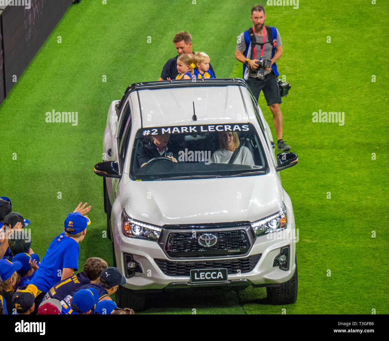 West Coast Eagles retiring  footballer Mark Lecras and children on the back of a Toyota vehicle lap of honour Optus Stadium Perth WA Australia. Stock Photo