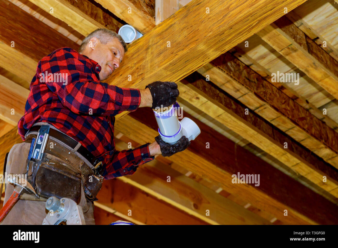 Prepare a pipe with primer and glue to PVC drain pipe Stock Photo Alamy