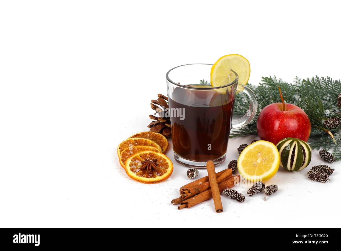 Winter hot drink - christmas tea or mulled wine - glass cup with spices and fruits,  christmas tea or mulled wine  isolated on white Stock Photo